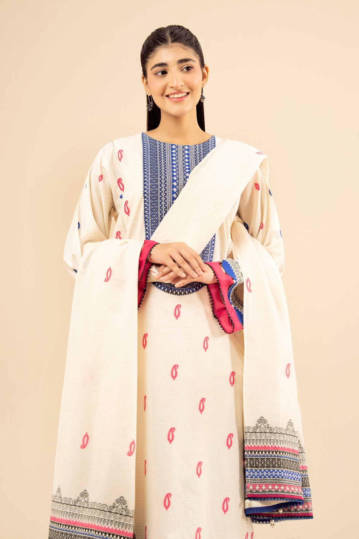White printed suit with blue patterned neckline, pink motifs and bordered dupatta, upper-body view
